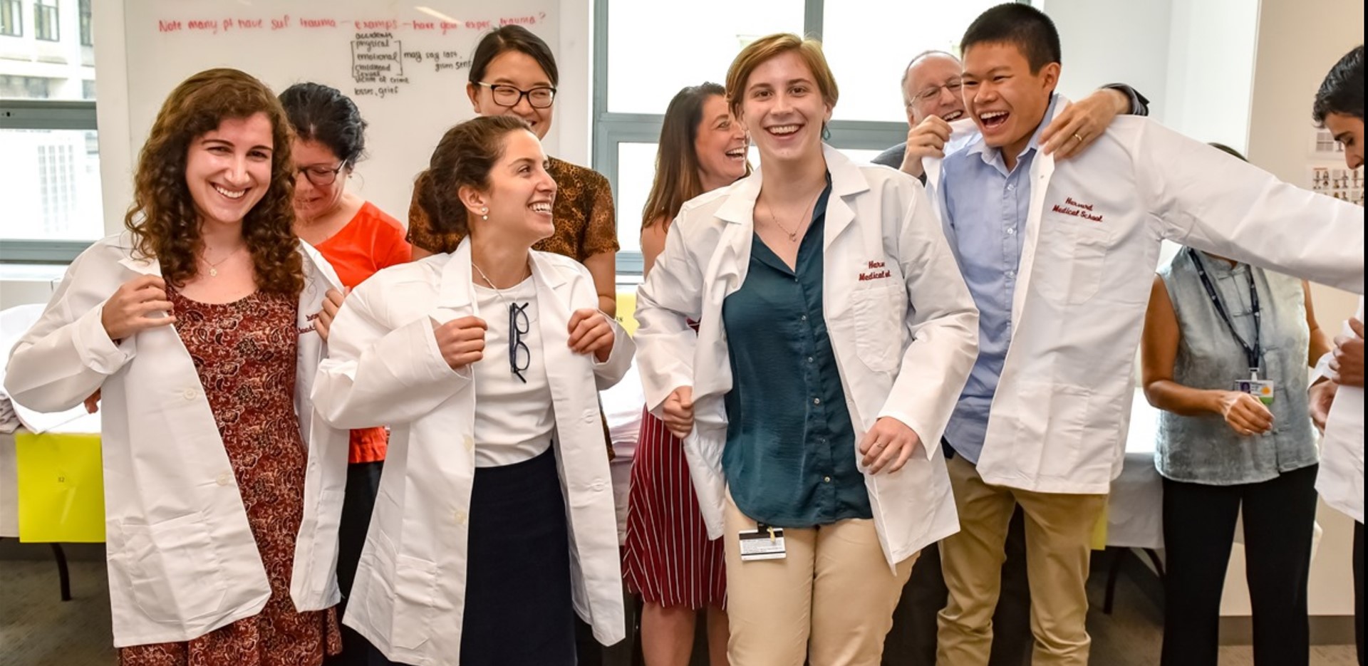 These students are thrilled to have received their white coats. Image: Steve Lipofsky for Harvard Medical School