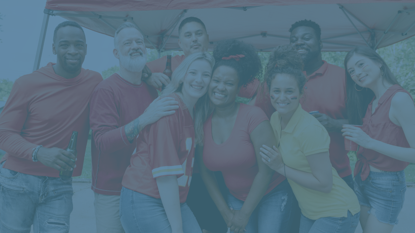 Alumni volunteers celebrating at a tailgate sports party